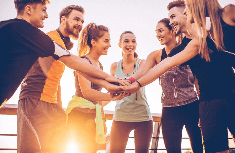 General Outpatient Program A group joining hands together